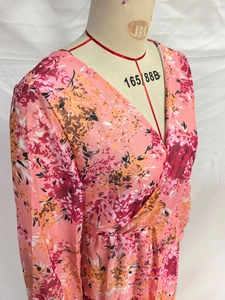 Detailed view of floral print chiffon dress with V-neck wrap design and cinched waist