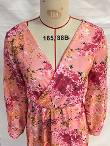 Detail of V-neckline and high waist on pink floral chiffon dress with long sleeves
