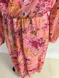 Detailed view of summer floral dress with elastic waist and vibrant pink chiffon print
