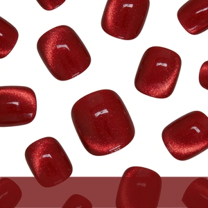 Sparkling deep ruby red cat eye press-on toenails with shimmering pearl finish