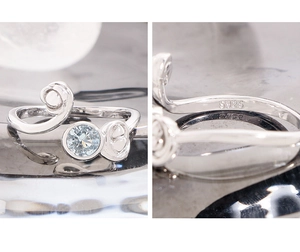 Macro shot of S925 sterling silver hallmark and light blue zircon on an asymmetric ring