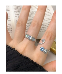 Close-up of S925 silver open ring featuring light blue zircon and floral details