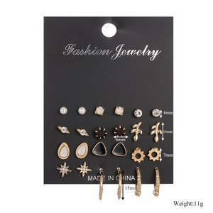 Detail of 12 pairs assorted earring set with pearls and rhinestones on card display