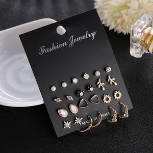 9-pair vintage gold earring set with cross stars, faux pearls and crystals on card