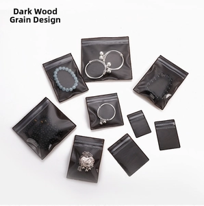 Macro shot of dark wood grain PVC jewelry pouches for organizing rings and bracelets