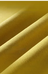 Detailed close-up of yellow Sorona cotton fabric with cooling and UV protection texture
