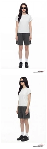 Detailed view of white short sleeve T-shirt and grey sports shorts outfit