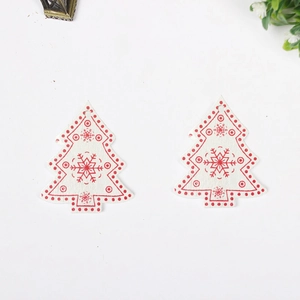 Close-up of white wooden Christmas tree pendant with red snowflake prints and DIY hole