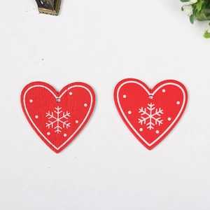 Two red wooden heart ornaments with white snowflake silk-screen printing for Christmas