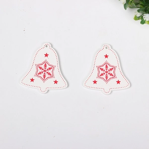 Detail of wooden Christmas bell ornaments with red snowflake and star patterns