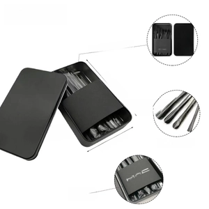 Detailed view of 12-piece soft fiber makeup brush set in a compact black metal storage box