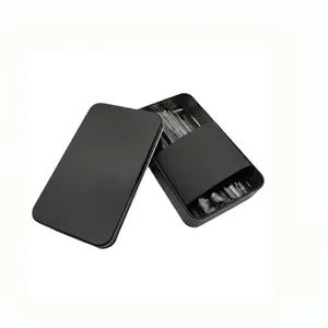 Detail of multi-row transparent nail tips secured in a minimalist matte black tin box