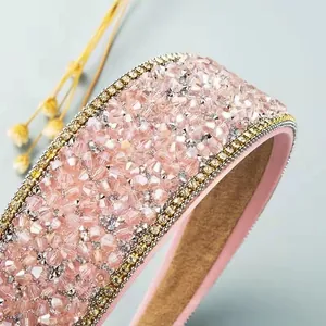 Macro detail of wide pink crystal headband with sparkling rhinestones and non-slip lining