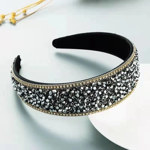 Detail of wide sparkling headband with grey crystals and gold bead chain trim