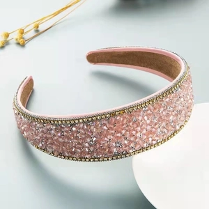 Detail of pink crystal beaded wide headband with gold accents on velvet lining