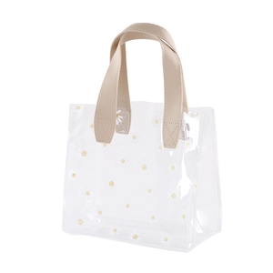 Transparent PVC tote bag with white daisy prints and light brown synthetic leather handles