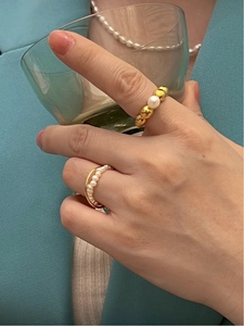 French vintage gold rings with freshwater pearls shown on model in a classic scene