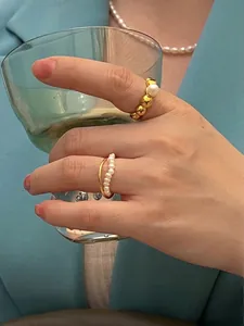 French vintage waterproof gold ring set with freshwater pearls on elegant blue blazer