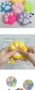 Detail of colorful plush cat paw squishy toys showing soft texture and squeezable material