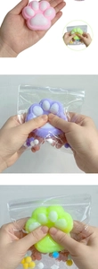 Macro shot of colorful squishy cat paw stress toys being squeezed showing elastic texture