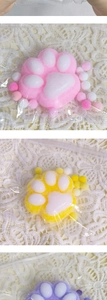Detailed view of DIY cat paw plush charms in pink, yellow and purple with fuzzy balls