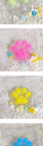 Detail of colorful cat paw squishy toys with star sequins in individual packaging
