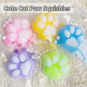 Soft cat paw squishy toys in 5 colors on white lace fabric, stress relief plush squeeze toys