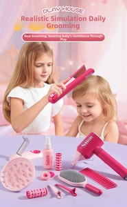 Close-up of kids hair salon playset with pink hair dryer and accessories in use