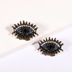 Vintage evil eye heart earrings with blue crystals and bronze metal frames