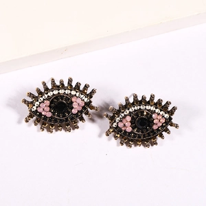Exaggerated evil eye heart crystal stud earrings with vintage gold metal and pink rhinestones