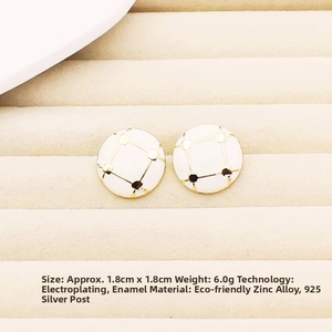 Detail shot of vintage 1.8cm white enamel earrings with golden cross pattern and 925 silver needles