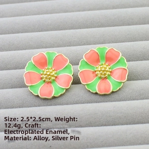 Detail of vintage flower stud earrings in green and pink enamel with 2.5cm size mark
