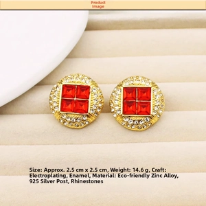 Detail view of gold round studs with red enamel and small white rhinestones