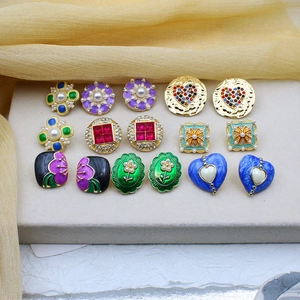 Vintage enamel earring set with faux pearls and crystals on gold silk background
