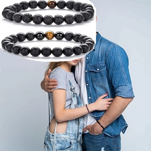 Lava stone and tiger eye bead bracelets shown on a couple with a detailed macro insert