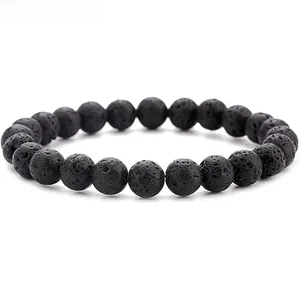 Macro detail of natural black lava stone beads with porous texture on elastic bracelet