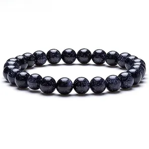 Macro shot of blue sandstone bracelet beads showing starry sky texture and sparkles