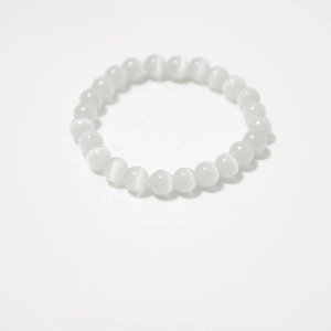 Close-up of white translucent cat eye beads bracelet showing cat-eye light effect