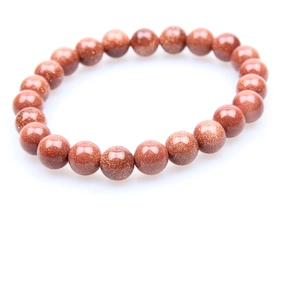 Detailed view of natural goldstone bead bracelet with sparkling metallic inclusions