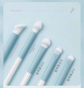 Detailed view of 5 soft blue eyeshadow brushes including blending and nose shadow tools