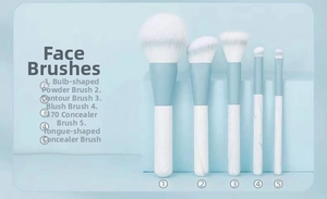 Close-up of 5-piece makeup brush set with marble handles and soft white bristles