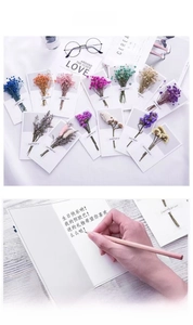 Detailed view of assorted dried flower greeting cards with blue, pink and purple bouquets