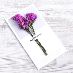 Detail of purple dried flowers fixed on a white gift card with Especially for you text