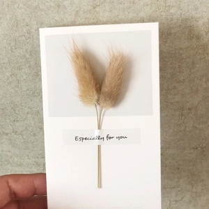 Detail showing handmade greeting card with natural dried flowers and special message