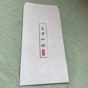 Macro shot of traditional calligraphy envelope with paper texture on linen fabric
