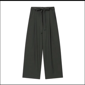 Detail of high-waist wide-leg trousers with matching bow belt in dark grey finish