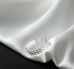 Detail of 925 sterling silver ring showing the hallmark and hollow lace texture