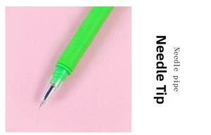 Close-up of a green cartoon monkey gel pen showing the precision needle point tip detail