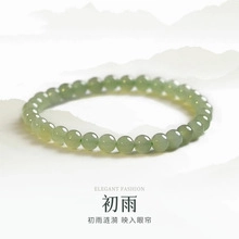 Detailed view of elegant light green nephrite jade beaded bracelet with polished finish