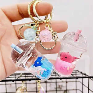 Acrylic milk tea cup keychain with liquid floating sand, whale model and glitter balls